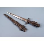 A late 19th century Continental dagger, the bronze hilt cast with three lovers, the reticulated