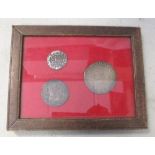 Three English hammered coins in a frame, to include an Elizabeth I half crown, a shilling, and a