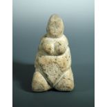 A carved white stone fertility figure of a seated female nude, possibly ancient 17cm (7in)