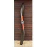 A WWI Avro biplane propeller, together with a photocopied photo of the propeller on the plane, the