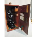 A J Swift & Sons microscope with black painted body, contained in a teak case, 41 cm (16in) high,