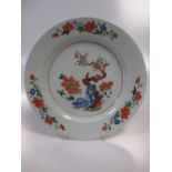 An 18th century Chinese famille verte plate with a cherry tree, blue rock and peonies centrally