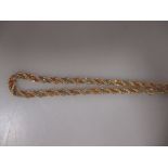 A yellow metal rope link chain with twisted rose and white metal box link chain decoration,