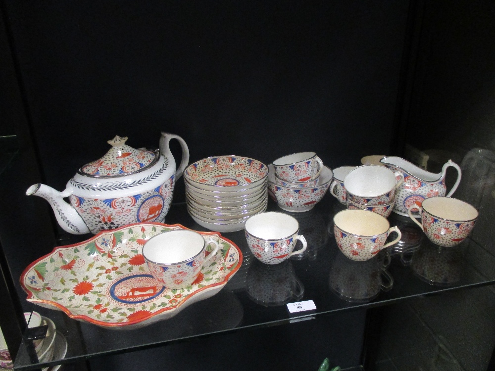 An early 19th century part teaset with naieve 'lion' motif decoration within panels, with 10 cups