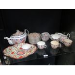 An early 19th century part teaset with naieve 'lion' motif decoration within panels, with 10 cups