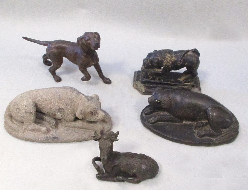 Two early 19th century Indian carved stone figures of lying dogs, and an earlier carved stone figure