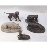 Two early 19th century Indian carved stone figures of lying dogs, and an earlier carved stone figure