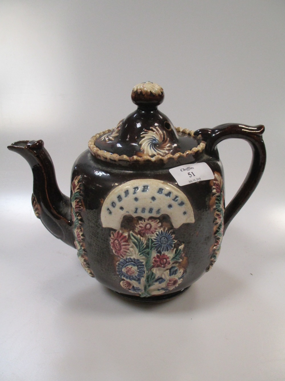 A 19th century bargeware teapot and cover, applied with a plaque incised 'Joseph Sale 1884'
