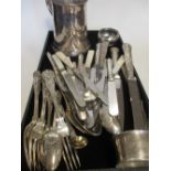 A collection of silver cutlery and flatware comprising four table knives, four dessert spoons, three