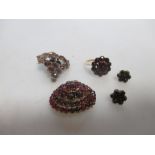 A suite of garnet set earrings, ring and brooch/pendant and a further garnet set brooch (4)