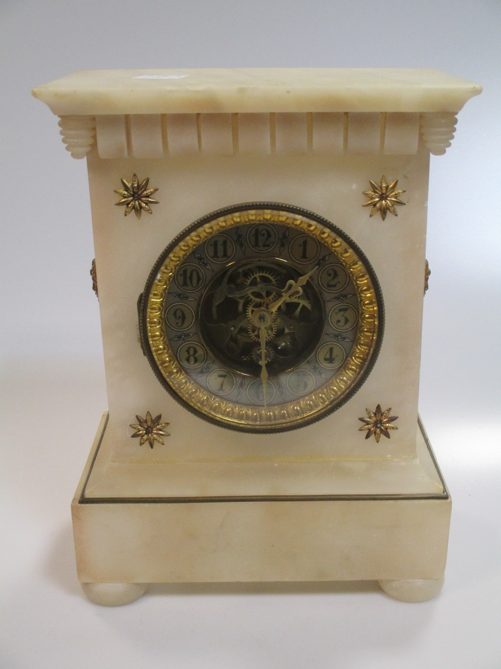 An alabaster case mantel clock with visible movement, 27 x 19cm