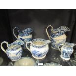 Five 19th century Staffordshire blue and white jugs; a 'Boy's Fishing' pattern jug; a Riley