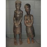 A pair of early 20th century East African carved hardwood tribal figures, possibly Tanzanian, the