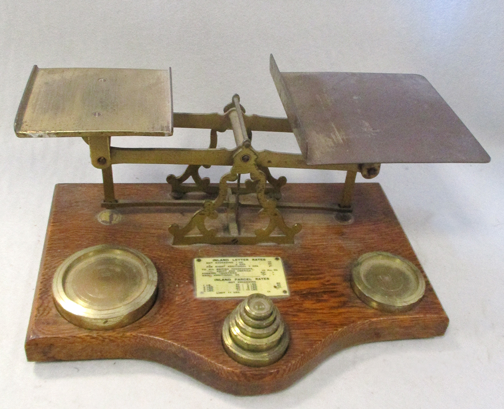 A set of 19th century oak and brass mounted postal scales, with ivorine letter rates plaque, 33cm (