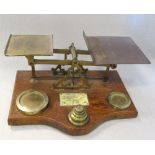 A set of 19th century oak and brass mounted postal scales, with ivorine letter rates plaque, 33cm (
