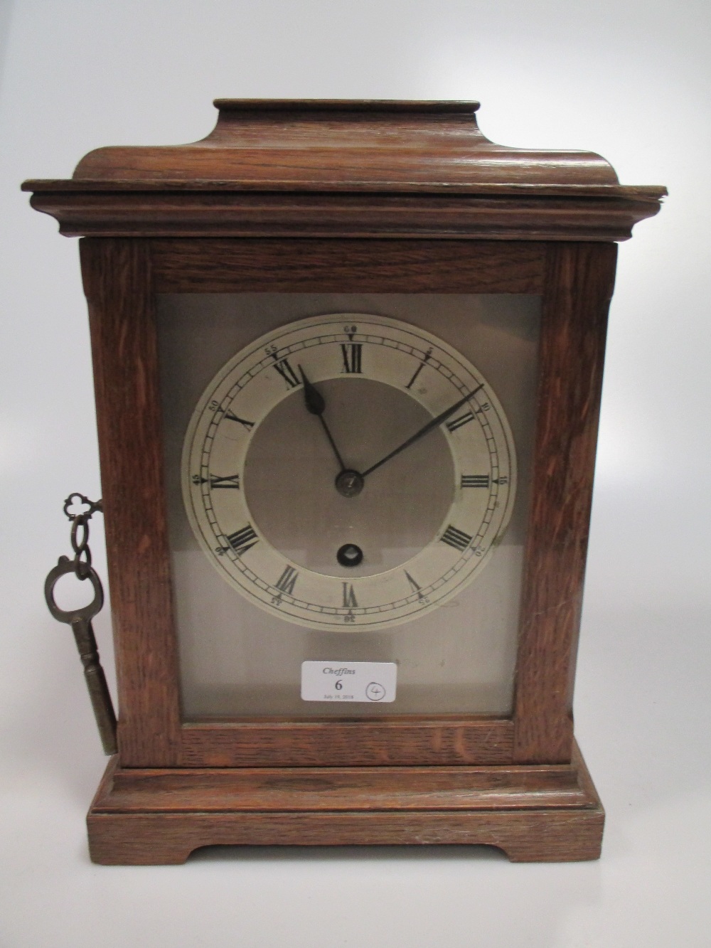 An oak mantel timepiece with German movement and two other small walnut case timepieces, and one