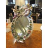 A Continental porcelain encrusted oval easel mirror, in Meissen style