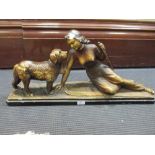 An Art Deco painted plaster model of a female skier and a dog 33cm high
