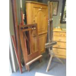 An Edwardian easel by Robinson & Co; another easel on a tripod base and a tapestry hanging pole (3)