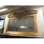 An 18th century style gilt framed overmantle mirror with break arch pediment and husk swag