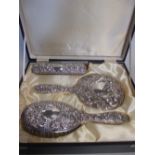 A cased silver backed four piece dressing table set by B & Co, Birmingham