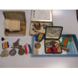 A collection of war and other medals and badges, with associated paperwork.