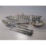 A collection of silver items including two dishes, two pierced dishes, two toast racks, two button