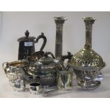 A collection of silverplated items including a pair of candlesticks, a pair of salad servers, two