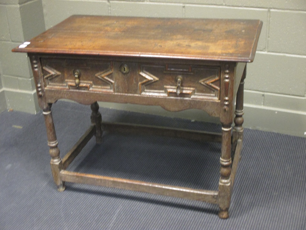 A late 17th century oak side table with geometric moulded drawer fronts, 70 x 93 x 53m