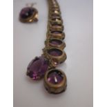 A purple stone necklace and brooch (2)