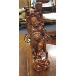 A carved Eastern hardwood figural lamp, (base 52cm high)