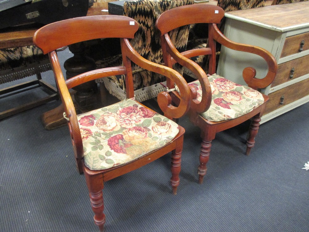 A pair of 19th century elm panel seat elbow dining chairs on turned legs (2)