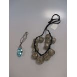 A silver bobble necklace and a blue glass necklace (2)