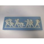 A Wedgwood blue jasperware plaque, sprigged with a frieze of cherubs, stamped 'WEDGWOOD' 7.5 x 21cm