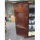 An 18th century oak standing corner cupboard, 217 x 100cm