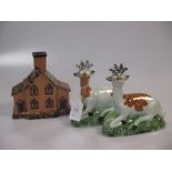 A pair of 18th century pearlware deer together with two Staffordshire cottages (4)