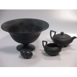 A Wedgwood black basalt teapot and milk jug, together with a black glass footed bowl etc.