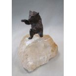 A silvered bronze model of a polar bear mounted to a rock crystal base, the figure standing on its