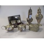 Two silver sugar casters, a pair of silver mustards, a cased pair of silver napkin rings & other