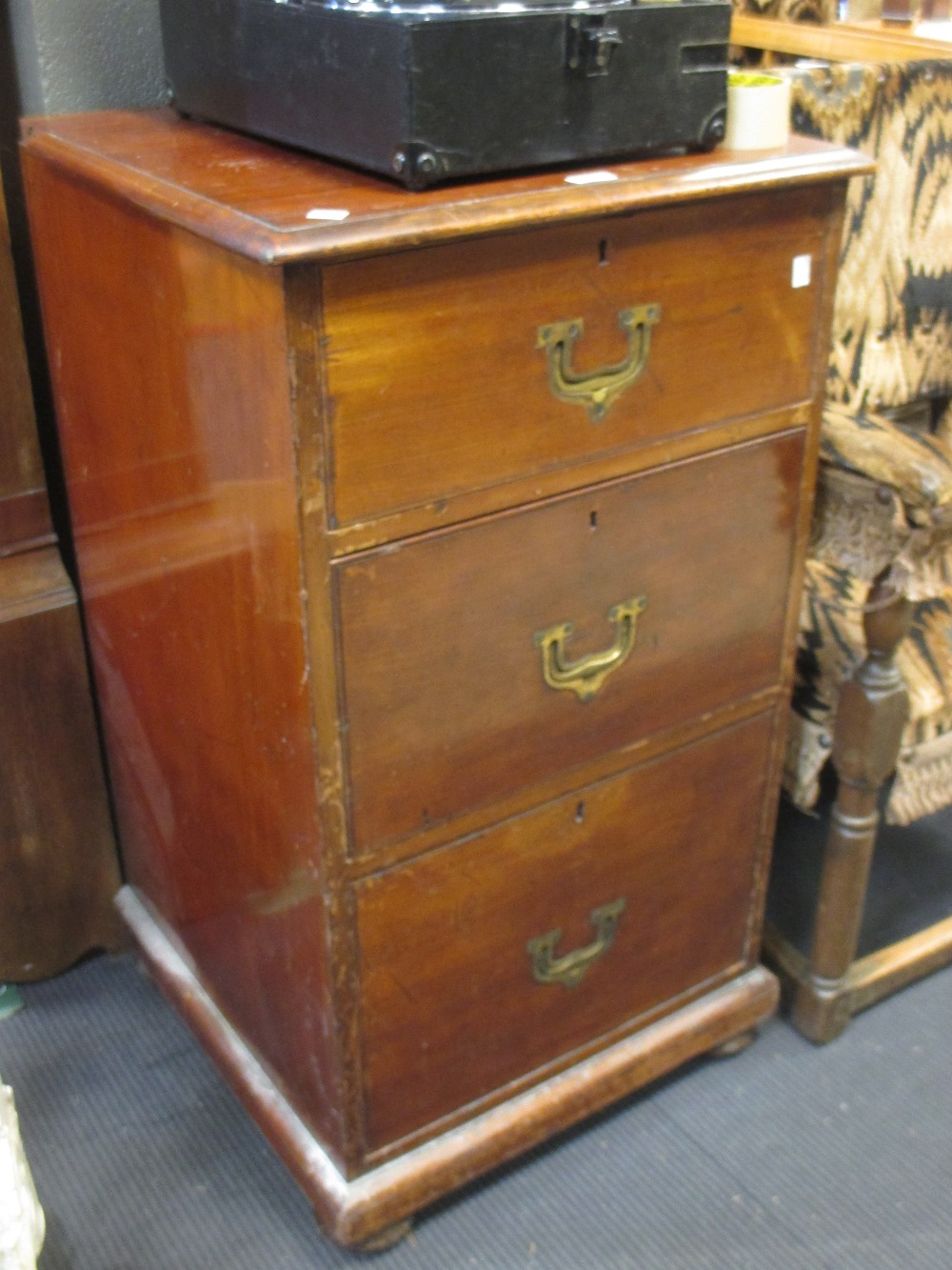 A mahogany three drawer chest with countersunk brass handles