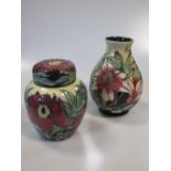 A modern Moorcroft 'Tree Peony' pattern ginger jar and cover and a Moorcroft 'Lilly' pattern vase (