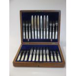 A cased set of 12 pairs of EPNS fruit eaters with mother of pearl handles and silver ferrules, a