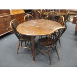 An 18th century oak drop leaf table and four wheel back chairs (5)