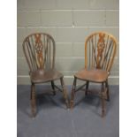 A set of nine ash and elm wheel back chairs