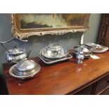 A collection of silver plated items including entree dishes and a kettle with spirit burner etc