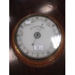 A Victorian oak circular aneroid barometer, a smaller aneroid barometer and a thermometer (3)