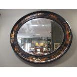 A black Chinoiserie oval framed wall mirror