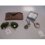 A pair of 1980s vintage Ray Ban sunglasses together with a shell cameo brooch depicting a rural