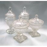 A pair of cut glass bon-bon jars and covers, the circular bodies with stylised fan rims, the stepped
