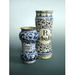 An 18th century Spanish Talavera blue and white albarello, of tall waisted cylindrical form,